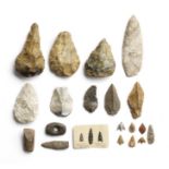 A collection of Palaeolithic and Neolithic axes and flint tools together with a large grey leaf-s...