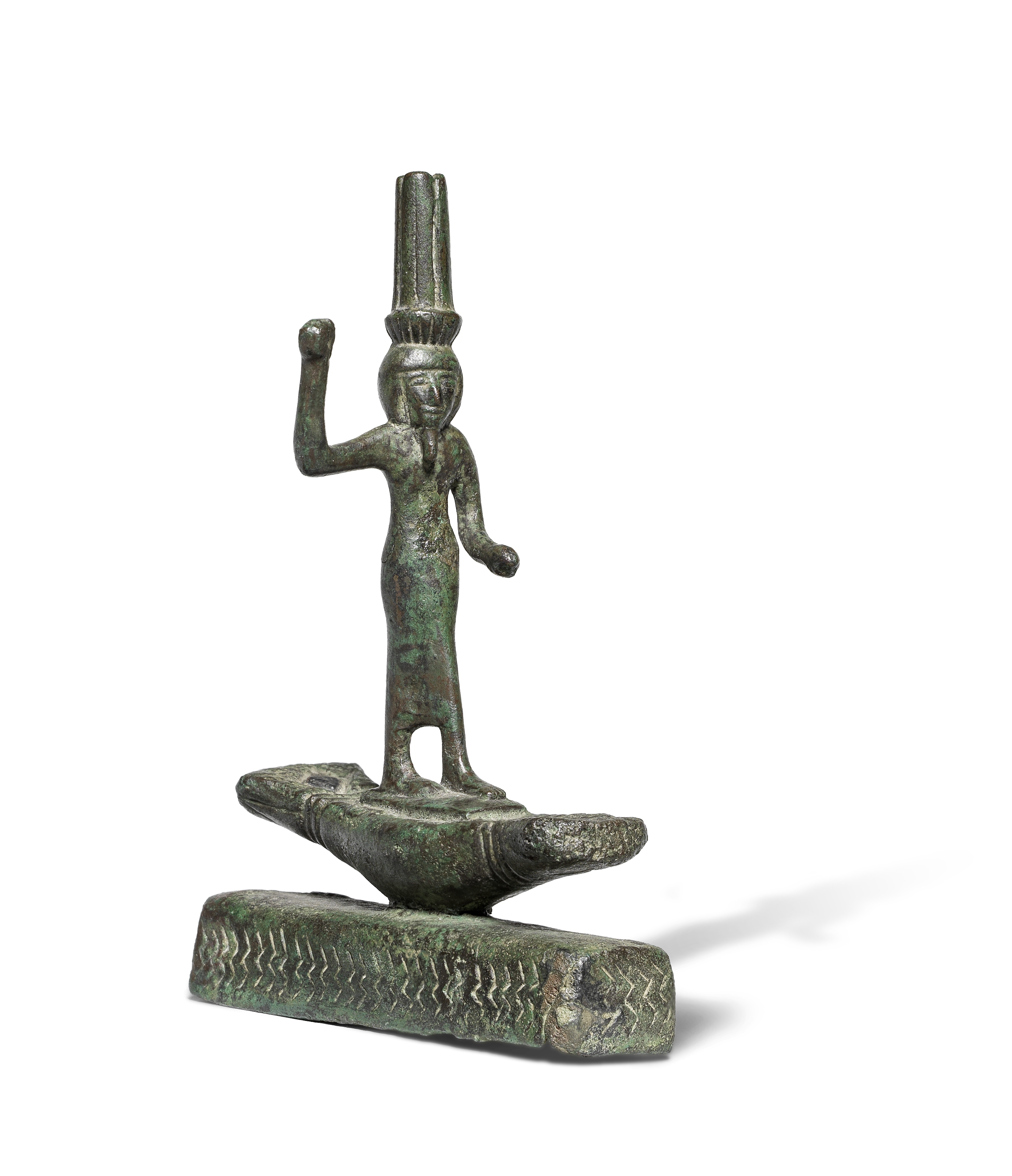 An Egyptian bronze figure of Onuris standing on a boat