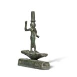 An Egyptian bronze figure of Onuris standing on a boat