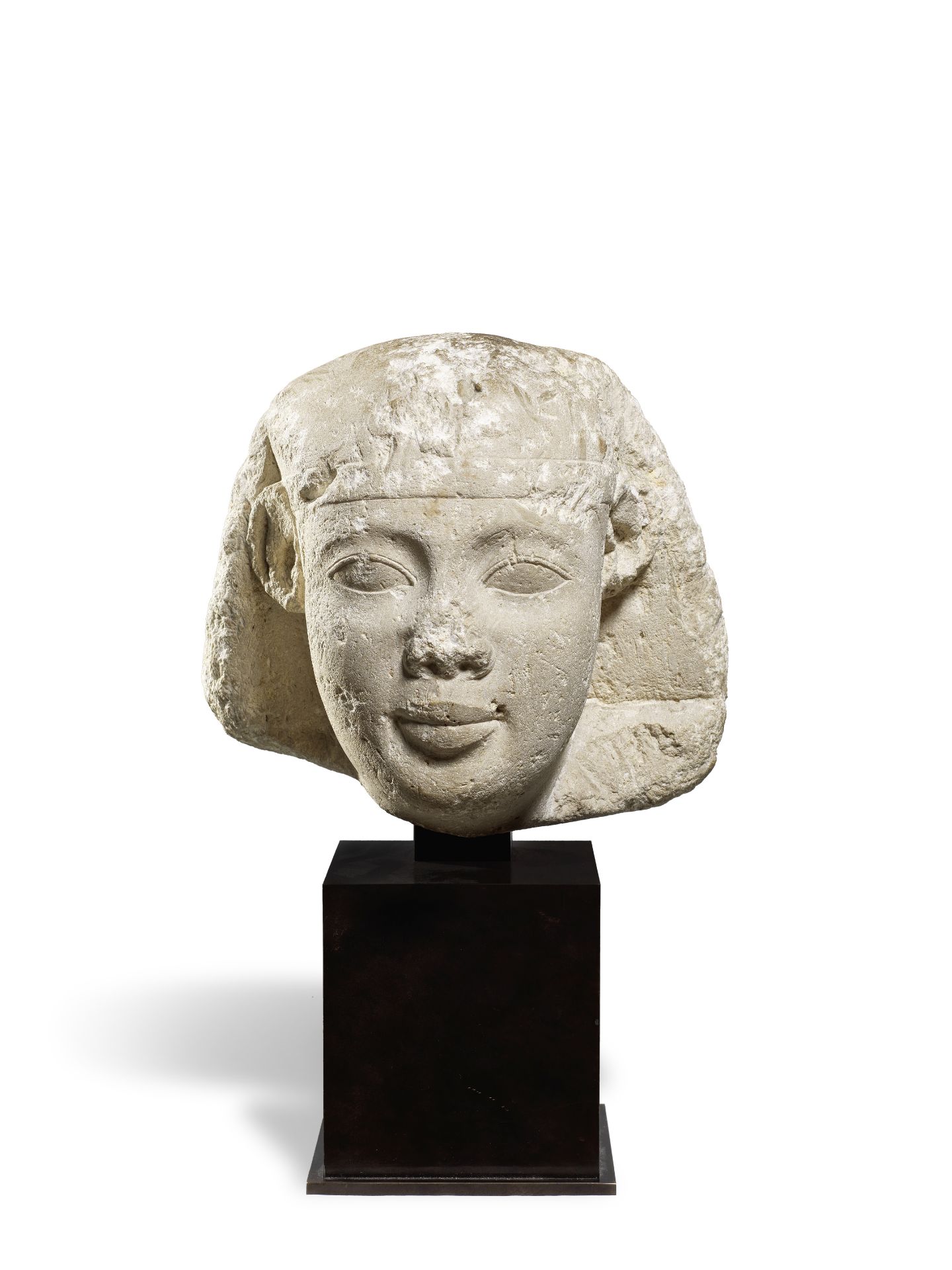 An Egyptian limestone head of a pharaoh