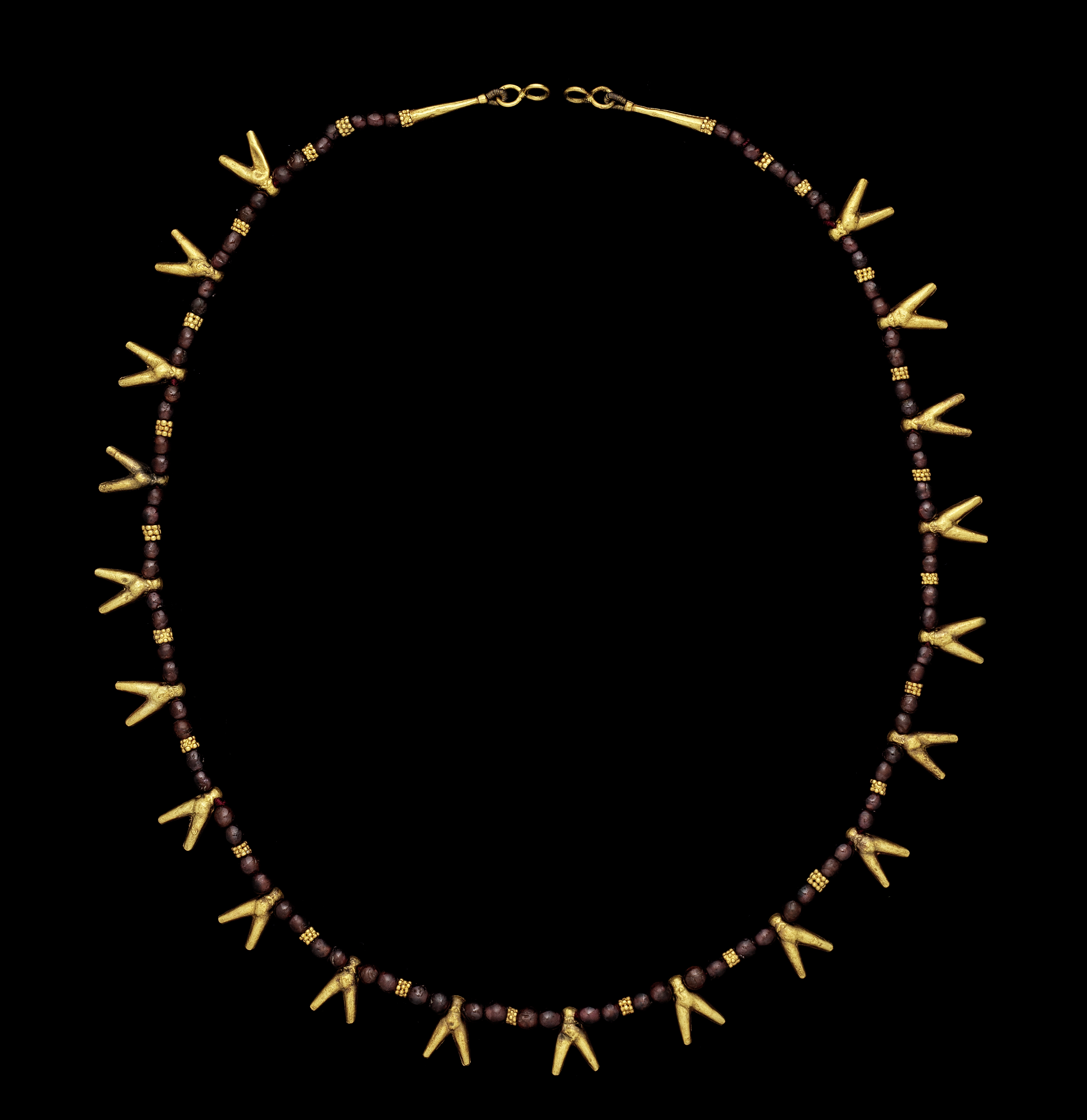 An Egyptian gold and garnet necklace with fly amulets