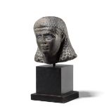 An Egyptian black granite head of a Queen