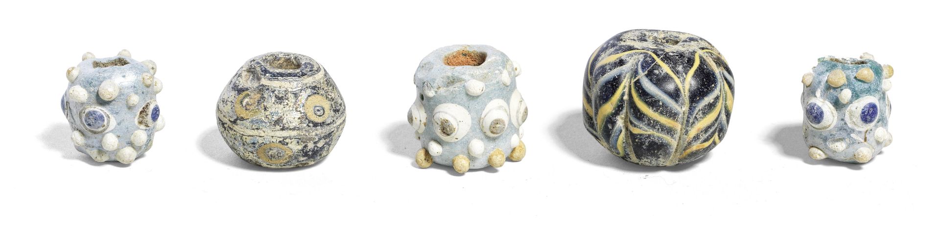 A group of four Phoenician glass core-formed beads and a Greek glass core-formed bead 5