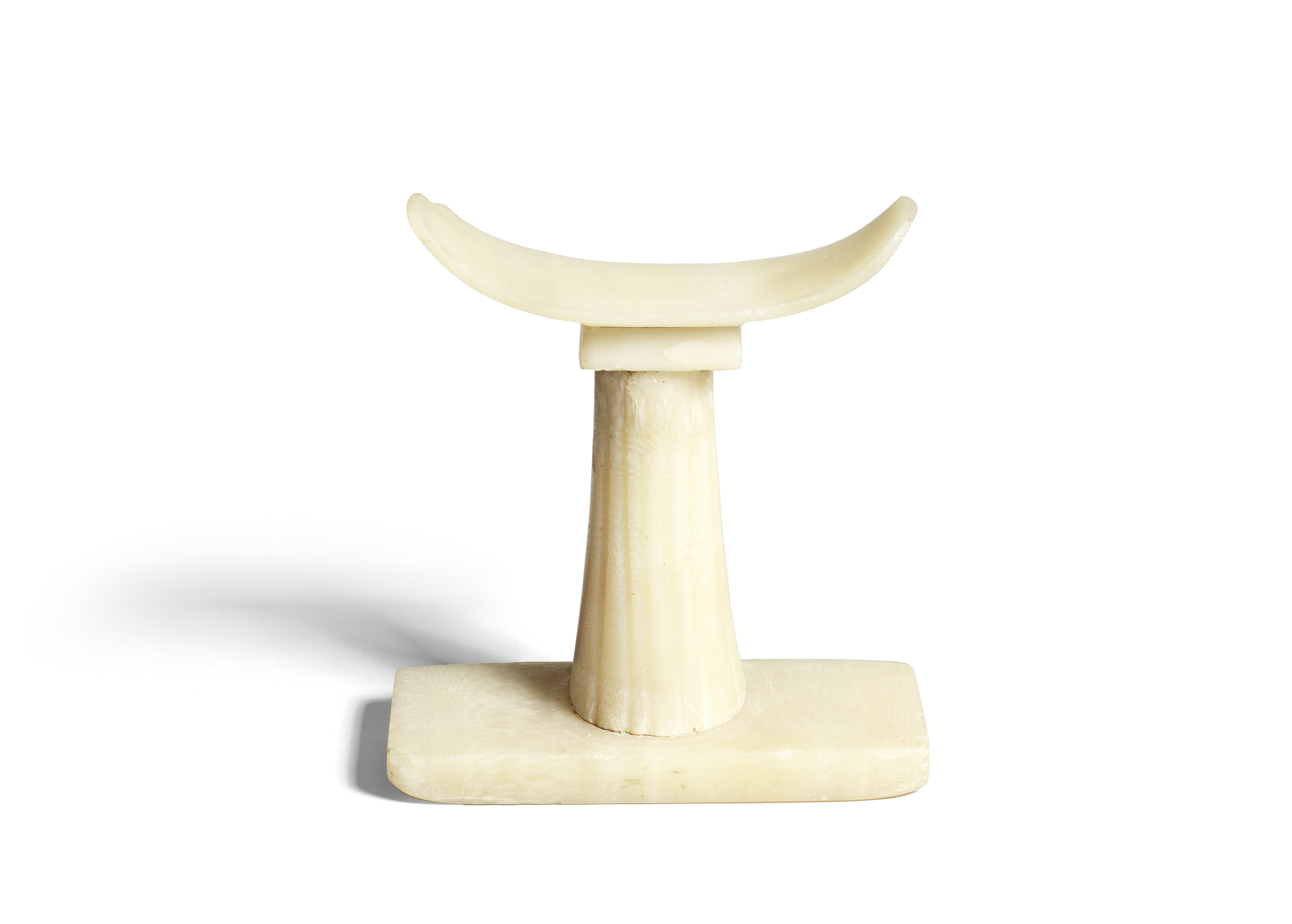 An Egyptian alabaster headrest