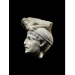 A Roman marble relief fragment with a male head