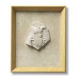 An Egyptian limestone sculptor's model fragment