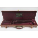 A single brass-mounted leather gun case, by Holland & Holland