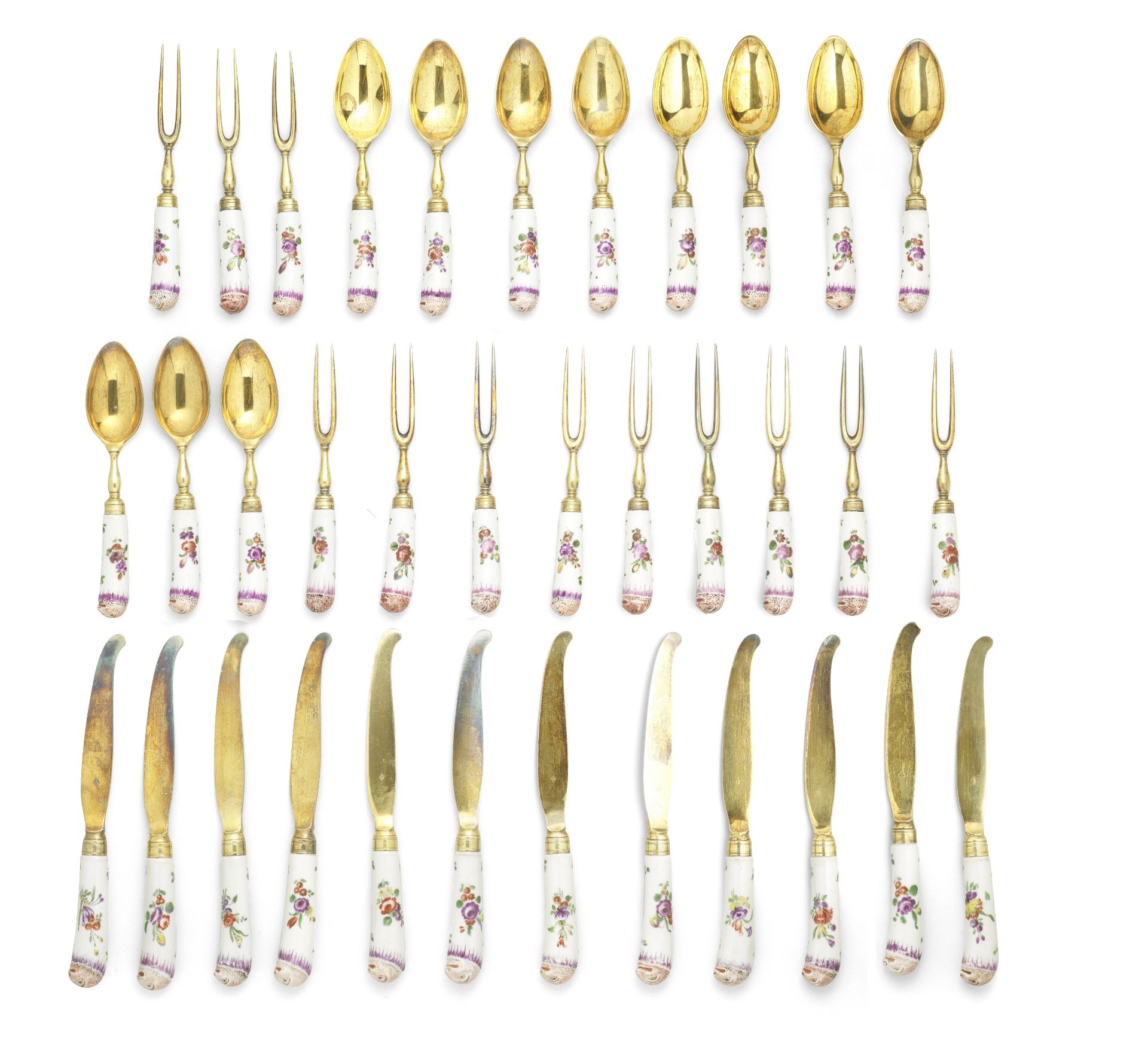 A cased set of silver-gilt-mounted Doccia cutlery handles, circa 1780, the cutlery by Luigi Verna...