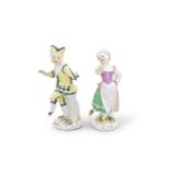 A Meissen figure of a boy from the Commedia dell'Arte, together with a Meissen girl holding a gob...