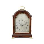 An early 19th century mahogany single pad top table clock with concentric date and pull repeat La...