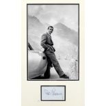 A photograph of Sean Connery as 007 with the Goldfinger Aston Martin DB5 in the Furka Pass, mount...