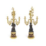 An important pair of Louis XVI gilt and patinated bronze and rouge griotte marble figural three l...