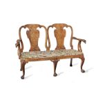 A George II carved walnut double chairback settee