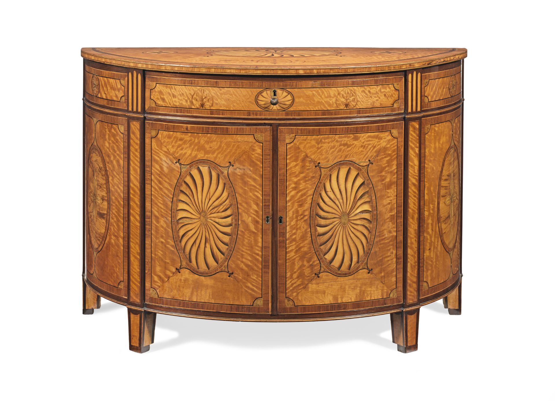 A George III satinwood, sycamore, kingwood, tulipwood, purplewood and marquetry demi-lune commode...