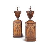 A matched pair of satinwood and carved mahogany urns and pedestals one urn and pedestal circa 177...