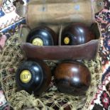 A Lot of four Antique Thomas Taylor of Glasgow Mahogany wooden bowling balls. Two have a leather