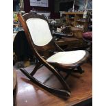 A Reproduction folding rocking chair.