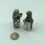 A Pair of heavy white metal Chinese Foo dogs seals.