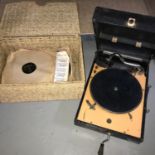 A Vintage Decca 10 portable gramophone with a basket of old records