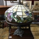 A Large Tiffany style table lamp, Detailed with an ornate metal base, Floral design stain glass