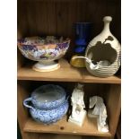 Two shelves of collectables which includes Victorian fruit bowl, Sculpture of a young boy, Onyx