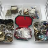A Lot of four plastic tubs of costume earrings and bangles together with jewel box containing