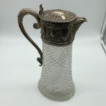 A London silver ornate top and handle claret jug with cut glass base. Silver made by William