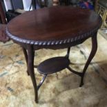 Antique Mahogany two tier window table in an oval form, supported on cabriole legs. Measures