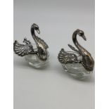 A Pair of Import London Sterling silver swan condiment pots with matching cherub topped spoons and