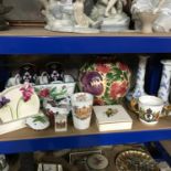 A Shelf of porcelain collectables which includes Wade hand painted bulbous vase, Paragon double