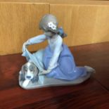 A Lladro figurine, girl with dog, 15cm in height