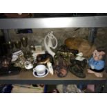 A Shelf of collectable odds which includes plated ware, ornate masks, carved wooden bear figure,