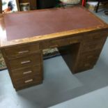 A vintage oak & leather top knee hole desk.