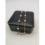 A Lovely example of a ladies 9ct gold and pearl necklace. 11 grams in weight. Chain measures