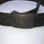 A WW2 German Nazi Gott Mit Uns belt buckle and leather belt.