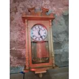 An Emperor wall clock in a light wooden case, with Westminster chime, complete with pendulum