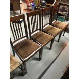 A Lot of four antique dining chairs. Designed with spindle back supports and spade feet.