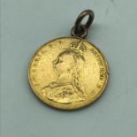 An 1887 Gold full sovereign coin. Has a gold hoop attached to the top.