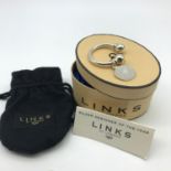 A Genuine Links of London solid silver keyring with certificate card, pouch and box.