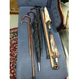 A selection of vintage walking sticks, umbrellas, parasols & measuring stick