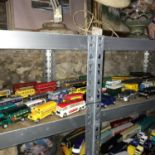 A Shelf of various bus models which includes Corgi.