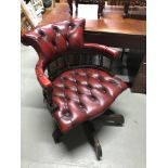 An Oxblood chesterfield captains chair.