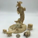 A Japanese Meiji period ivory hand carved figures of older gentleman and child, signature to the