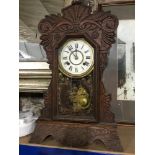 Antique American Ginger bread mantel clock, with key and pendulum. In a working condition.