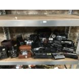 A Shelf of vintage cameras which includes Kodak, Yashica, Cosina CSM, Kodak bellow and box cameras