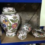 A lot of 4 pieces of hand painted Portuguese porcelain. Includes three bud style vases and large