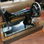 A Vintage singer sewing machine with carry case top.