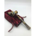 A Vintage set of opera glasses encased in paua shell with gilt brass trims. Comes with red