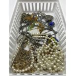 A Small basket of costume jewellery which includes some items of silver.