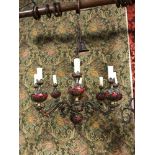 An early 1900's heavy bronze and red sphere design 8 branch chandelier.